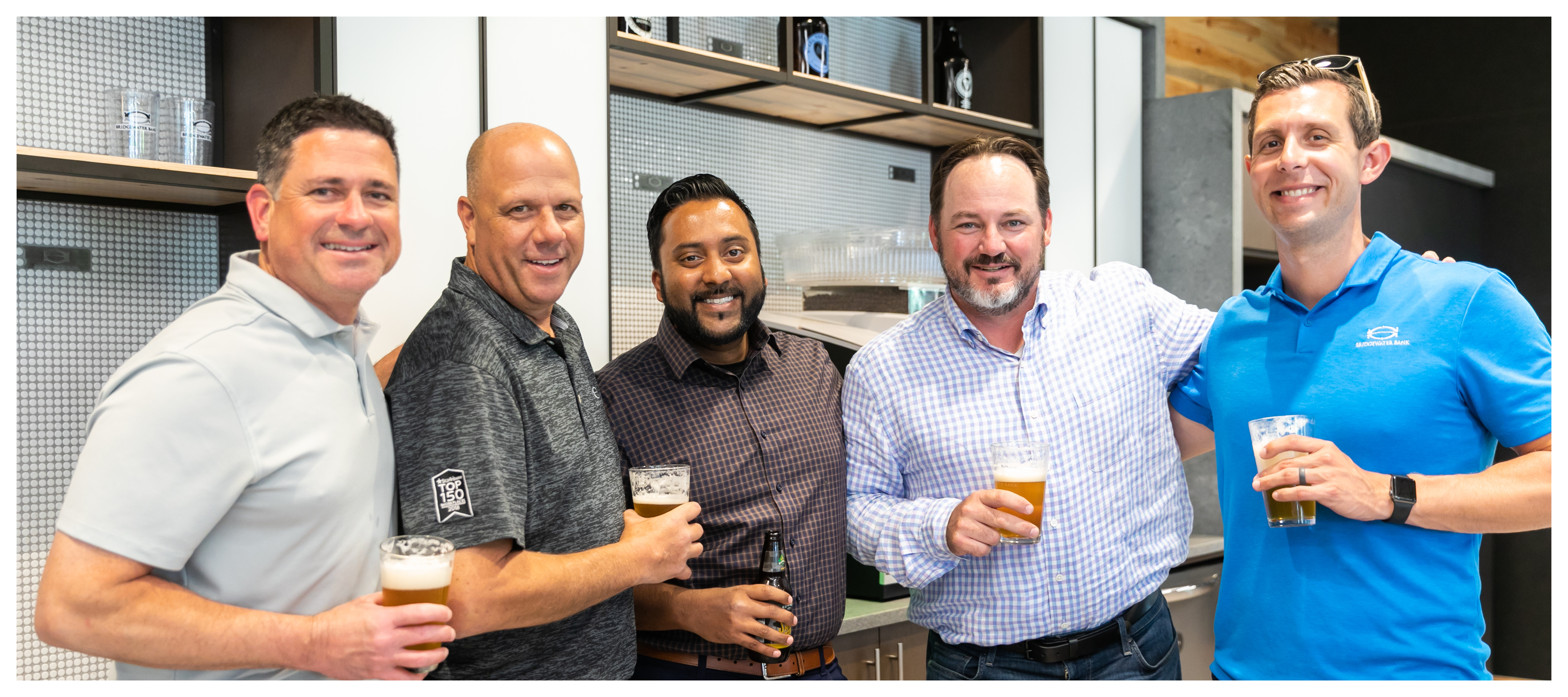 Group photo of Discovery Trust Group team members at an internal happy hour.